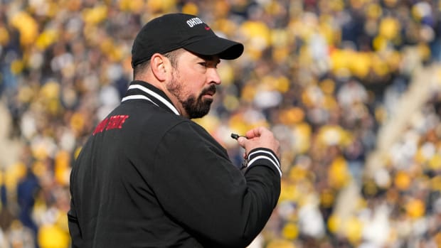 Ohio State Buckeyes head coach Ryan Day leads his team in warm-ups prior to the NCAA football game against the Michigan Wolverines at Michigan Stadium